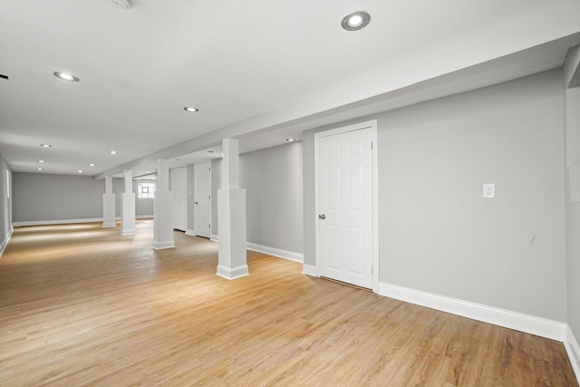 basement with baseboards, recessed lighting, and light wood-style flooring