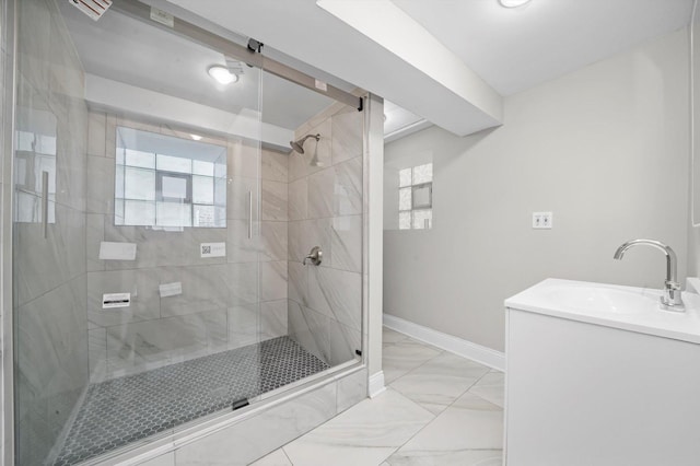 full bath featuring a shower stall, marble look tiles, baseboards, and vanity