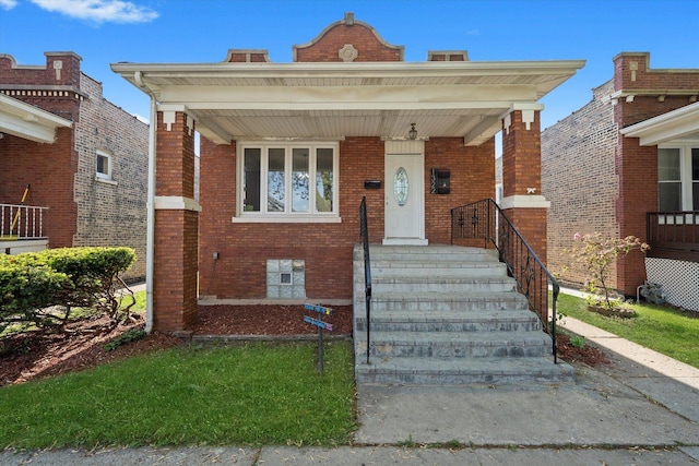 view of front of home with brick siding and covered porch