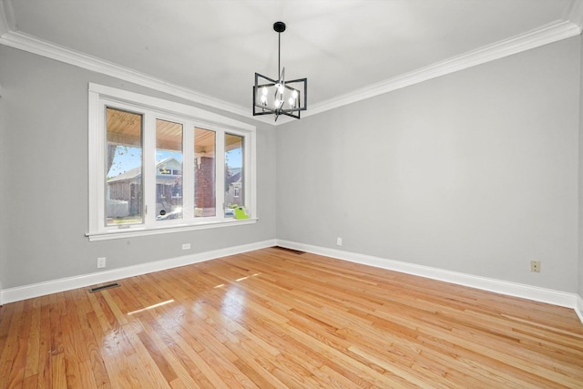 unfurnished room with crown molding, a chandelier, light wood-style floors, and baseboards