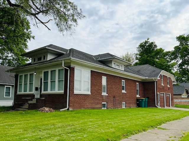 120 N Joliet St, Wilmington, IL 60481 - view of property exterior featuring brick siding, a lawn, entry steps, and roof with shingles