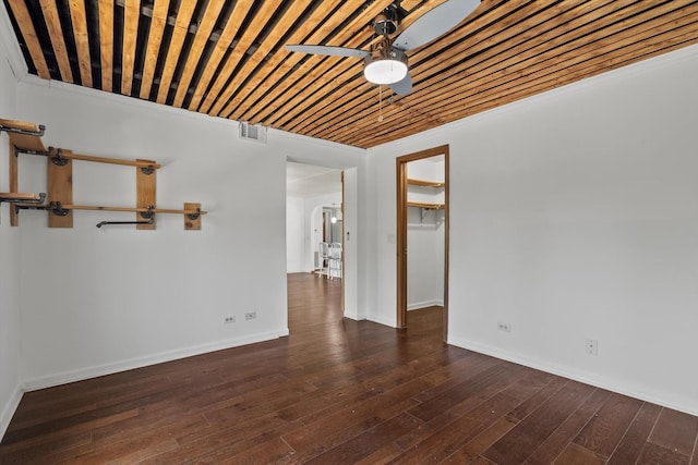 unfurnished room with a ceiling fan, wood finished floors, and baseboards