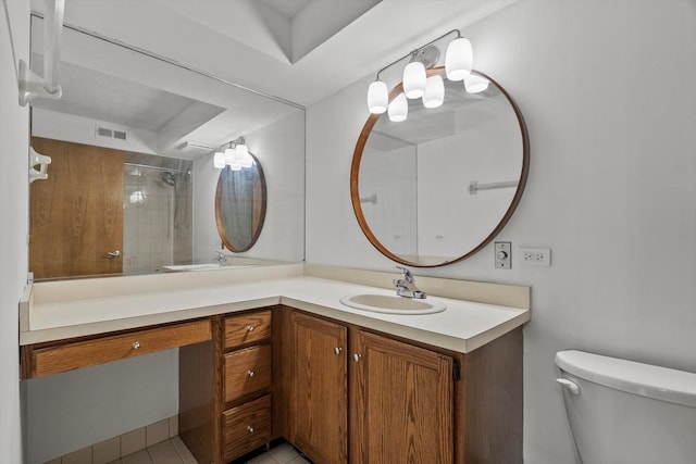 full bath with toilet, double vanity, and a tile shower