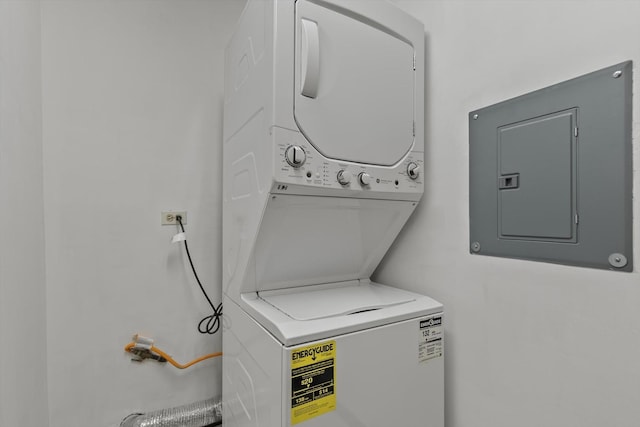 clothes washing area with stacked washer / drying machine and electric panel