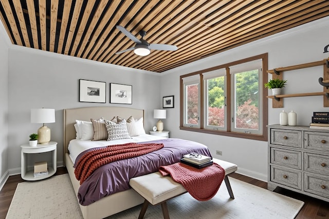 bedroom with dark wood-style floors, baseboards, and ornamental molding