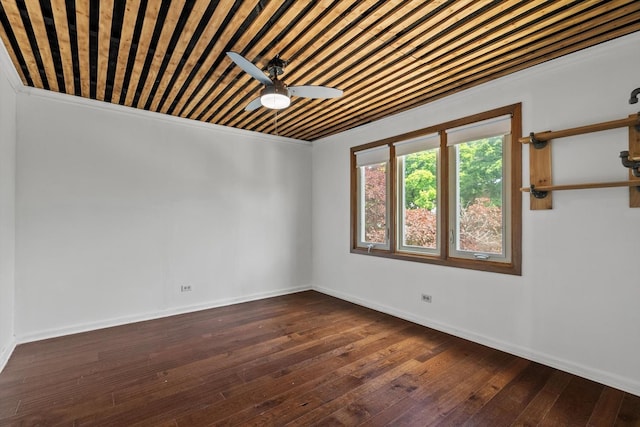 unfurnished room with a ceiling fan, dark wood finished floors, and baseboards
