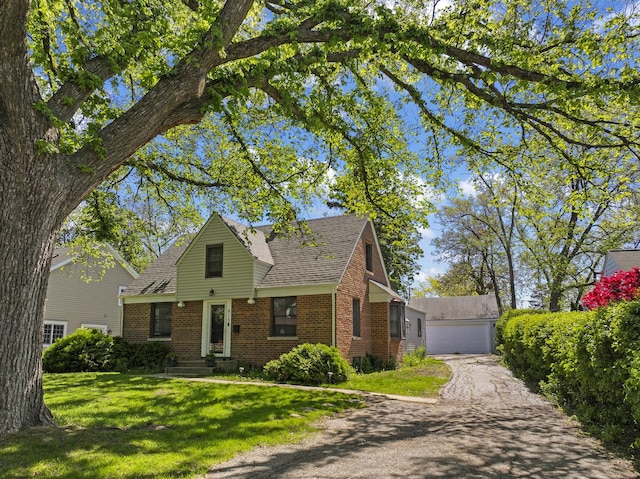 615 Hillside Rd, Glenview, IL 60025 - view of front of home with brick siding, an outbuilding, a front lawn, roof with shingles, and a garage