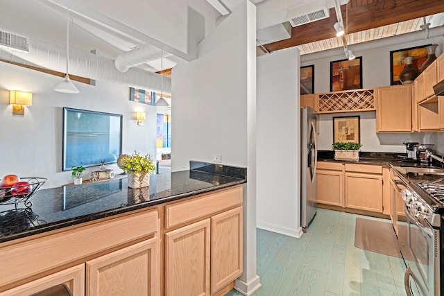 1725 W N Ave Unit 404, Chicago, IL 60622 - kitchen featuring appliances with stainless steel finishes, light brown cabinets, light wood finished floors, dark stone counters, and decorative light fixtures