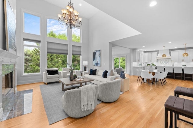 1410 W Newcastle Ct, Inverness, IL 60010 - living area with recessed lighting, a premium fireplace, light wood-style flooring, a towering ceiling, and a chandelier