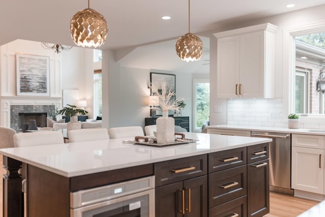 1410 W Newcastle Ct, Inverness, IL 60010 - kitchen featuring appliances with stainless steel finishes, white cabinetry, light countertops, tasteful backsplash, and recessed lighting