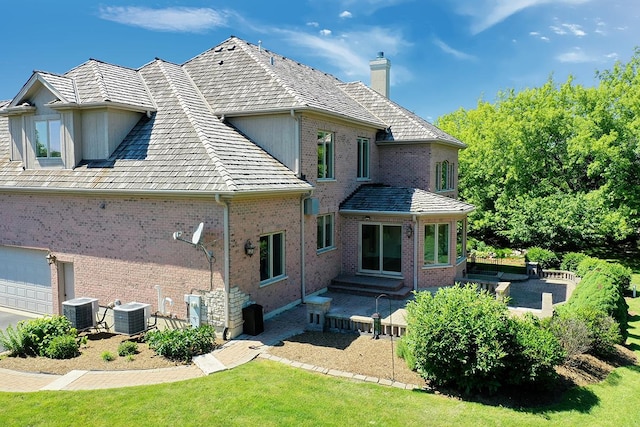 1410 W Newcastle Ct, Inverness, IL 60010 - back of house with a chimney, central air condition unit, brick siding, and a patio