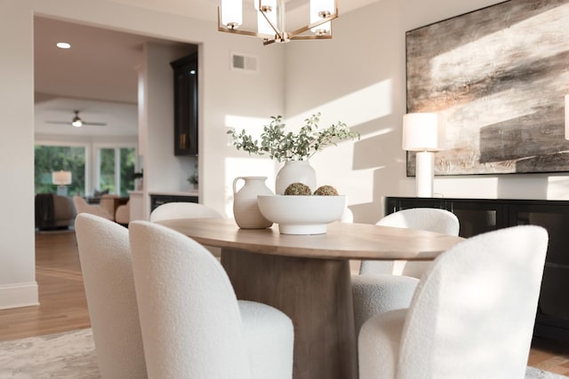 1410 W Newcastle Ct, Inverness, IL 60010 - dining space with a chandelier, a ceiling fan, and wood finished floors