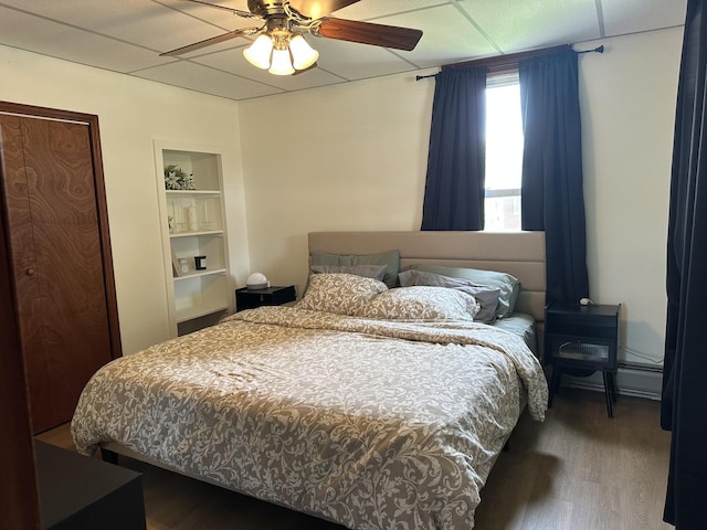 bedroom featuring wood finished floors and a ceiling fan