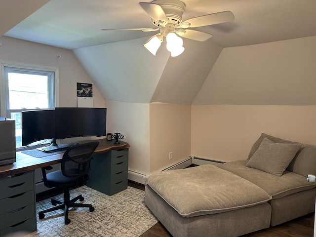 bedroom featuring baseboard heating, lofted ceiling, wood finished floors, ceiling fan, and an office area