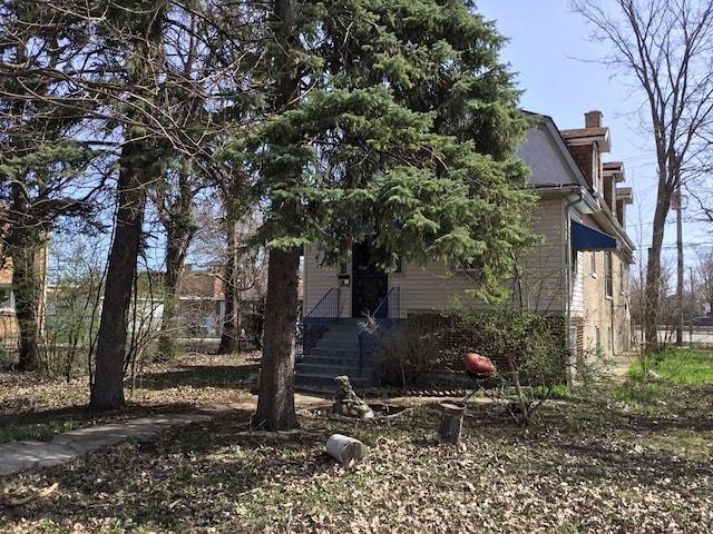 obstructed view of property featuring a chimney