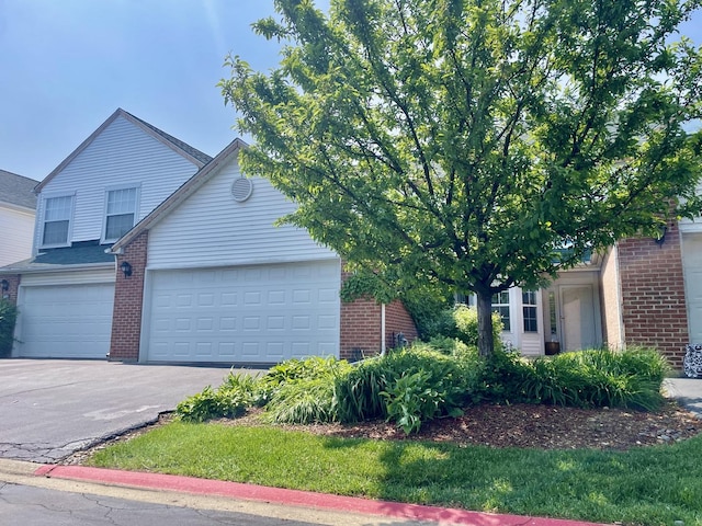 103 Hemstead St Unit 34-D, Lake Bluff, IL 60044 - obstructed view of property featuring brick siding, asphalt driveway, and a garage