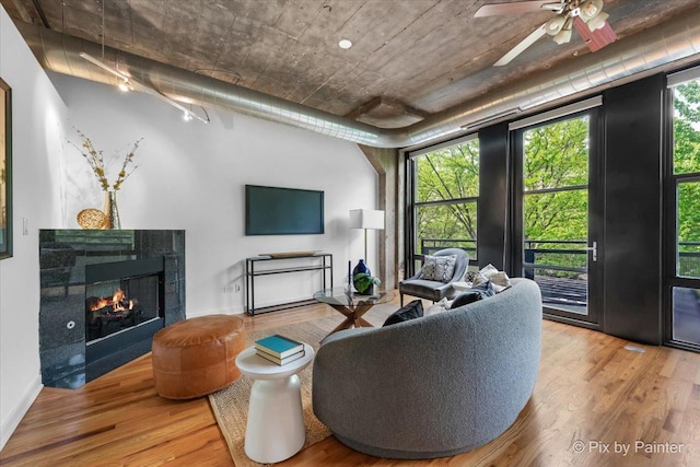 1001 W 15th St Unit 243, Chicago, IL 60608 - living room with wood finished floors, a fireplace, ceiling fan, and baseboards