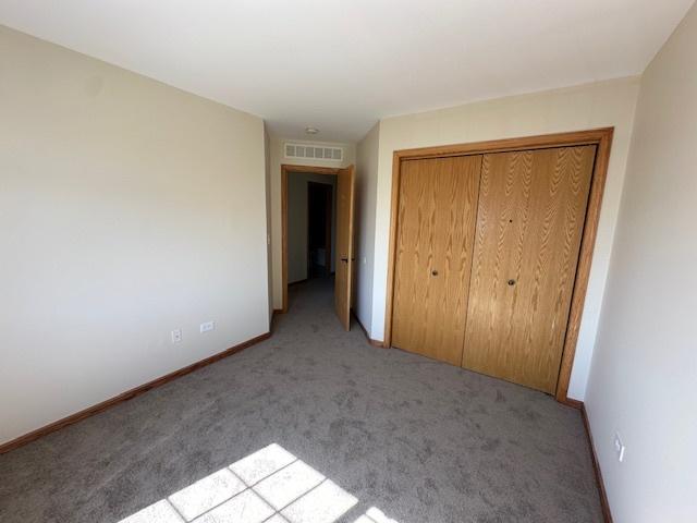 15810 Scotsglen Rd, Orland Park, IL 60462 - unfurnished bedroom with carpet floors, a closet, and baseboards