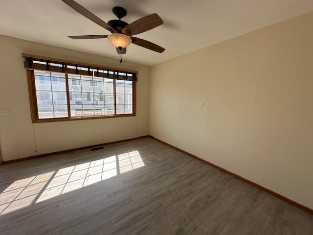 15810 Scotsglen Rd, Orland Park, IL 60462 - empty room with wood finished floors and baseboards