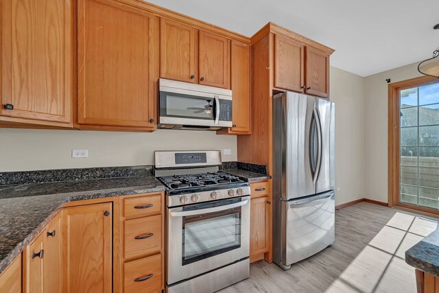 15810 Scotsglen Rd, Orland Park, IL 60462 - kitchen featuring stainless steel appliances, light wood-style flooring, and dark stone counters