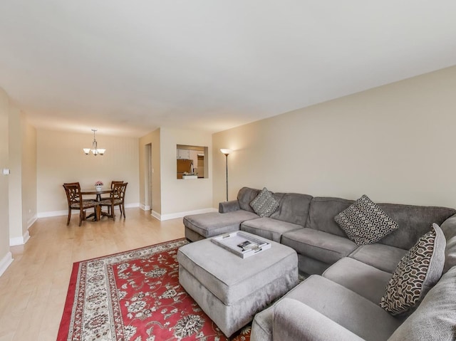 6660 S Brainard Ave Unit 103, Countryside, IL 60525 - living area featuring light wood finished floors, a chandelier, and baseboards
