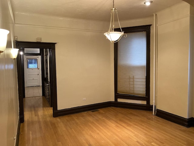 3320 W Monroe St, Chicago, IL 60624 - spare room with wood finished floors, baseboards, and arched walkways