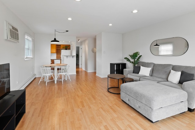 905 Graceland Ave Unit 12, Des Plaines, IL 60016 - living area featuring a baseboard heating unit, light wood-type flooring, a wall mounted air conditioner, recessed lighting, and baseboards