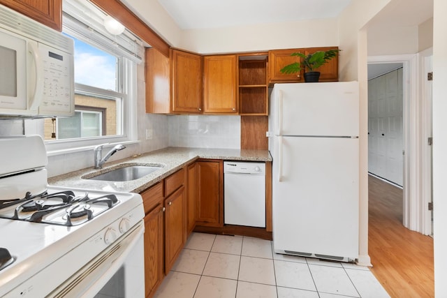 905 Graceland Ave Unit 12, Des Plaines, IL 60016 - kitchen featuring white appliances, a sink, brown cabinetry, light stone counters, and open shelves