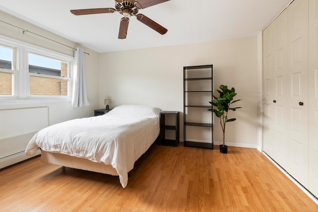 905 Graceland Ave Unit 12, Des Plaines, IL 60016 - bedroom featuring light wood-style floors, a ceiling fan, baseboards, and a baseboard heating unit