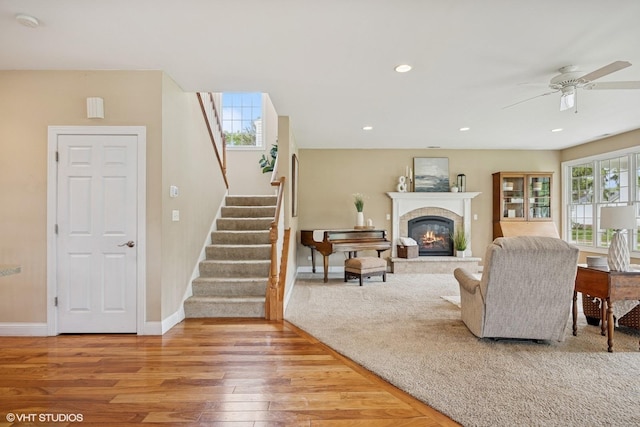 34017 N Prospect Dr, Grayslake, IL 60030 - living room with wood finished floors, baseboards, stairway, ceiling fan, and a glass covered fireplace