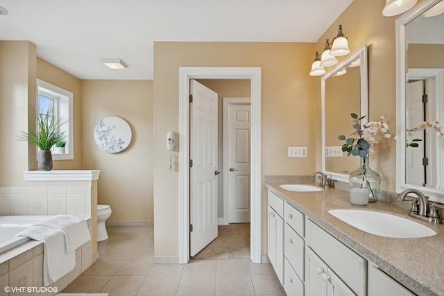 34017 N Prospect Dr, Grayslake, IL 60030 - full bathroom with double vanity, toilet, tile patterned floors, a garden tub, and baseboards