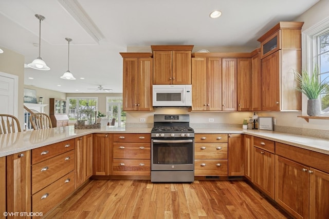 34017 N Prospect Dr, Grayslake, IL 60030 - kitchen featuring white microwave, gas range, light wood-style flooring, a peninsula, and recessed lighting