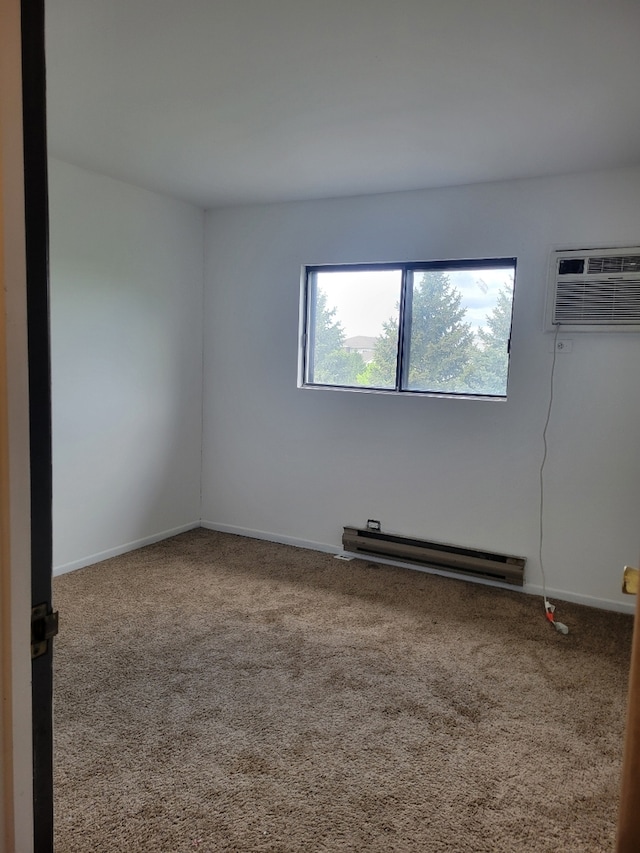 1140 Cedar St Unit 3A, Glendale Heights, IL 60139 - carpeted spare room featuring baseboard heating, a wall mounted air conditioner, and baseboards