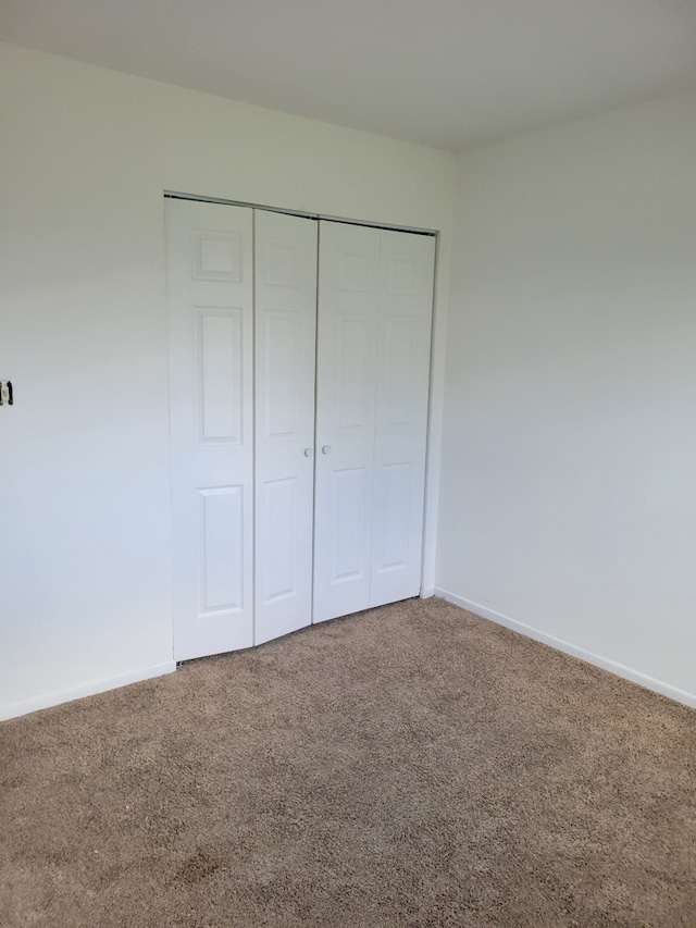 1140 Cedar St Unit 3A, Glendale Heights, IL 60139 - unfurnished bedroom featuring carpet flooring, baseboards, and a closet