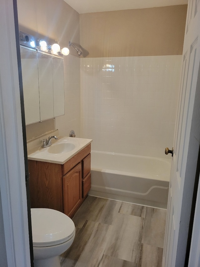 1140 Cedar St Unit 3A, Glendale Heights, IL 60139 - bathroom featuring vanity, toilet, wood finished floors, and shower / tub combination