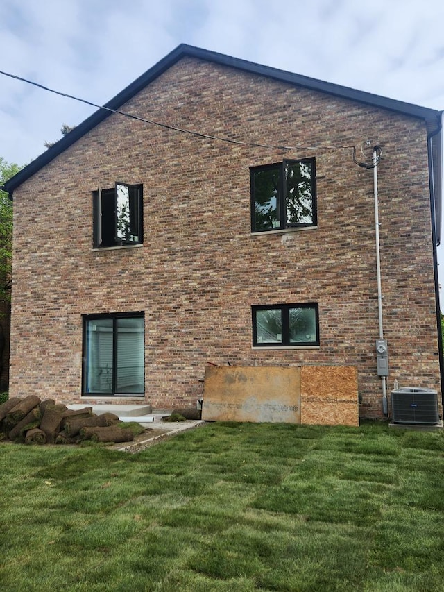 3811 W Pratt Ave, Lincolnwood, IL 60712 - rear view of property featuring a lawn, brick siding, and cooling unit