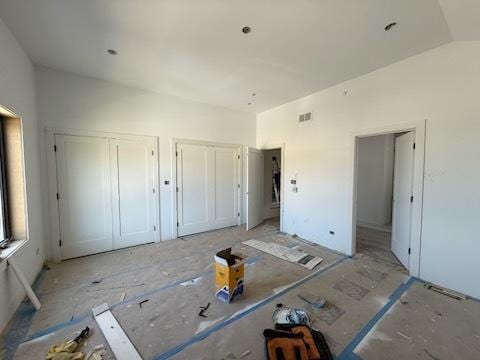 3811 W Pratt Ave, Lincolnwood, IL 60712 - unfurnished bedroom with multiple closets and lofted ceiling