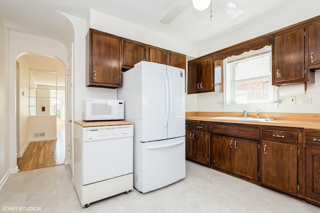 2852 W 84th Pl, Chicago, IL 60652 - kitchen featuring white appliances, a sink, arched walkways, a ceiling fan, and dark brown cabinetry