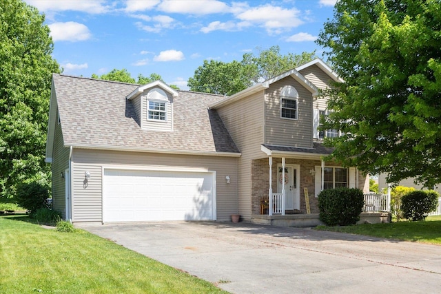 2697 Creekside Ln, Morris, IL 60450 - view of front of property with a porch, a garage, a shingled roof, concrete driveway, and a front yard