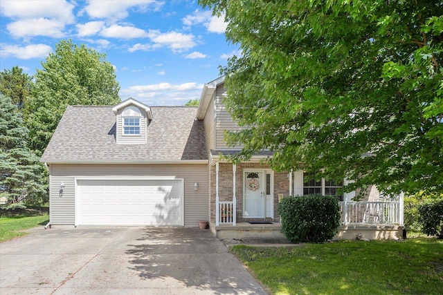 2697 Creekside Ln, Morris, IL 60450 - view of front of home with an attached garage, concrete driveway, a front yard, and roof with shingles