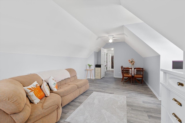 2697 Creekside Ln, Morris, IL 60450 - living room featuring light wood finished floors, vaulted ceiling, a ceiling fan, and baseboards