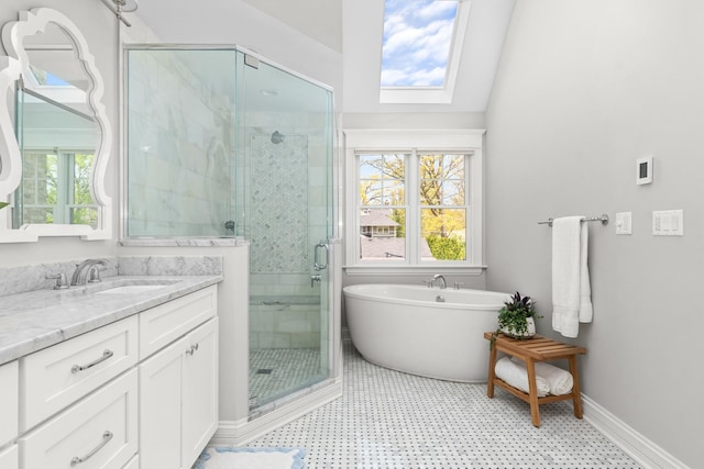 1100 Forest Ave, Wilmette, IL 60091 - full bath with a shower stall, vanity, a freestanding bath, a skylight, and baseboards
