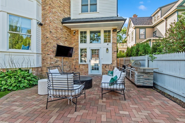 1100 Forest Ave, Wilmette, IL 60091 - view of patio featuring exterior kitchen and fence