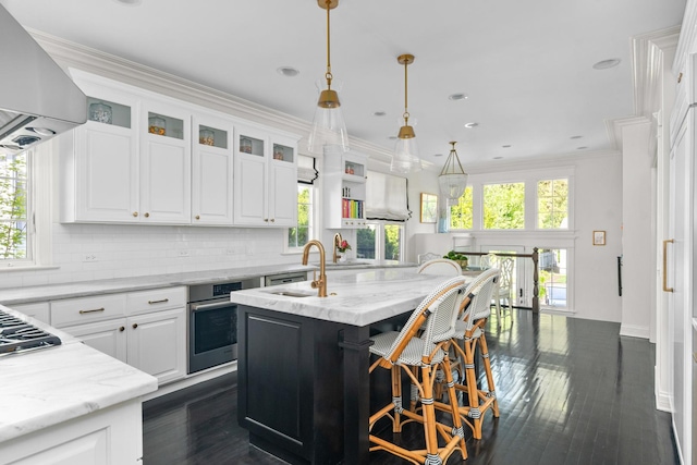 1100 Forest Ave, Wilmette, IL 60091 - kitchen with stainless steel appliances, range hood, decorative backsplash, plenty of natural light, and ornamental molding