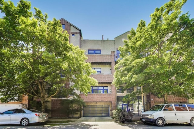 2251 W Saint Paul Ave Unit 2D, Chicago, IL 60647 - view of property featuring a garage and driveway
