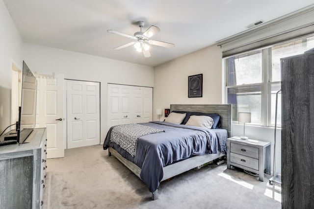 2251 W Saint Paul Ave Unit 2D, Chicago, IL 60647 - bedroom with light colored carpet, multiple closets, and ceiling fan
