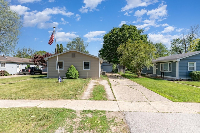 403 W School St, Plano, IL 60545 - view of front facade with driveway, a front lawn, and a detached garage
