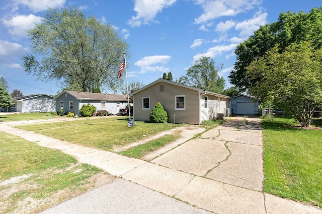 403 W School St, Plano, IL 60545 - view of front of home with concrete driveway, an outbuilding, a garage, and a front yard
