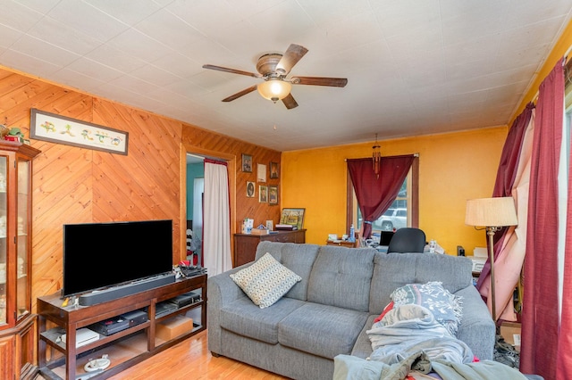 403 W School St, Plano, IL 60545 - living area with a ceiling fan, wood walls, and wood finished floors