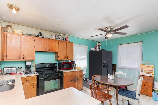 403 W School St, Plano, IL 60545 - kitchen featuring black appliances, ceiling fan, light countertops, and brown cabinets